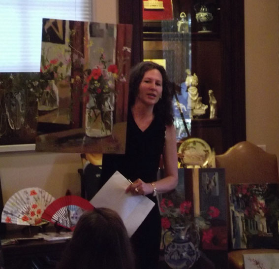 Young woman showing painting of poppies in a glass jar at the Casa de España