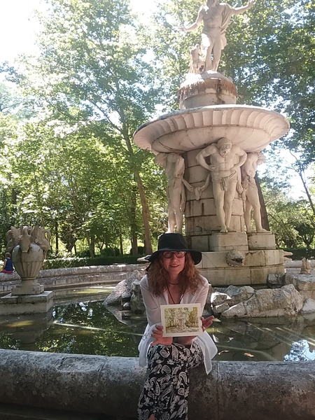 A photograph of me sitting on the edge of the Narciso fountain with a watercolor of the fountain in my hand.