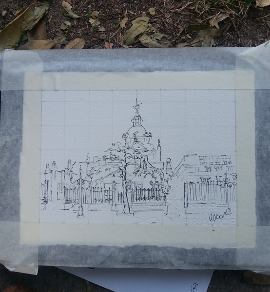 A photo of a pen and ink drawing of the Almudena Cathedral taped down to the drawing board.