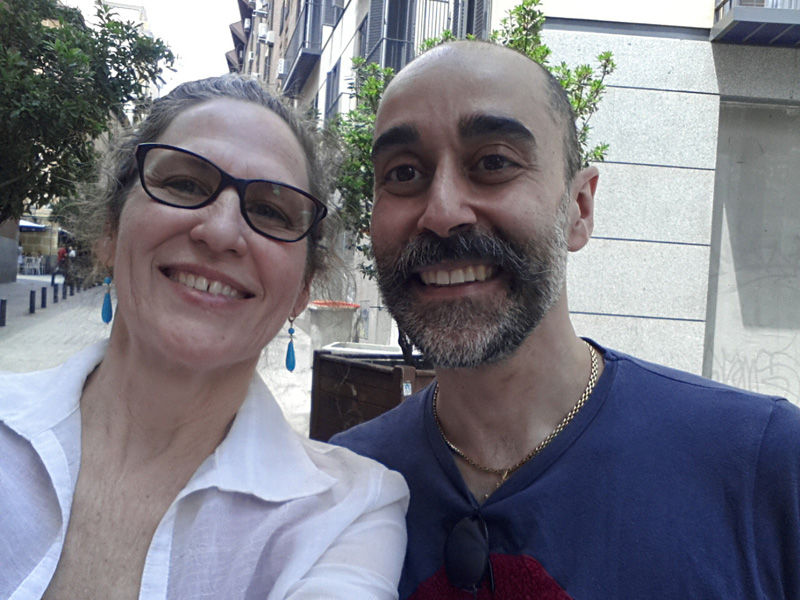 Two people looking into the camera lense with a smile.